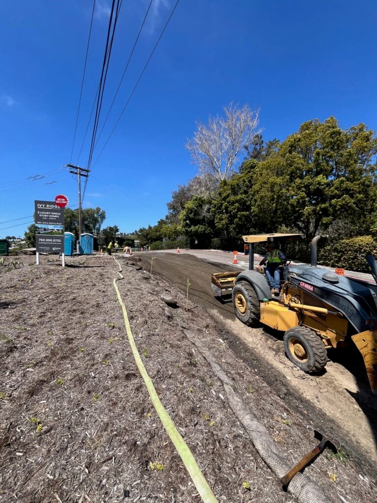 Asphalt contractor using heavy-duty machinery for paving work.