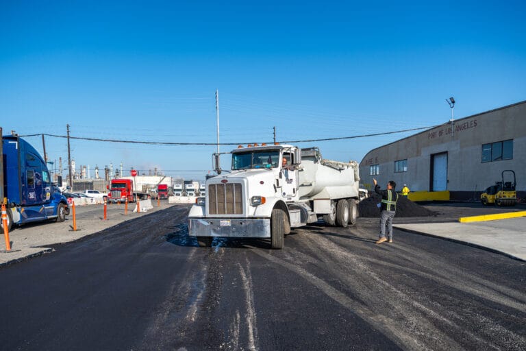 Asphalt paving truck working on a driveway project in Anaheim, showcasing Bay Cities Paving's expertise in local paving services.